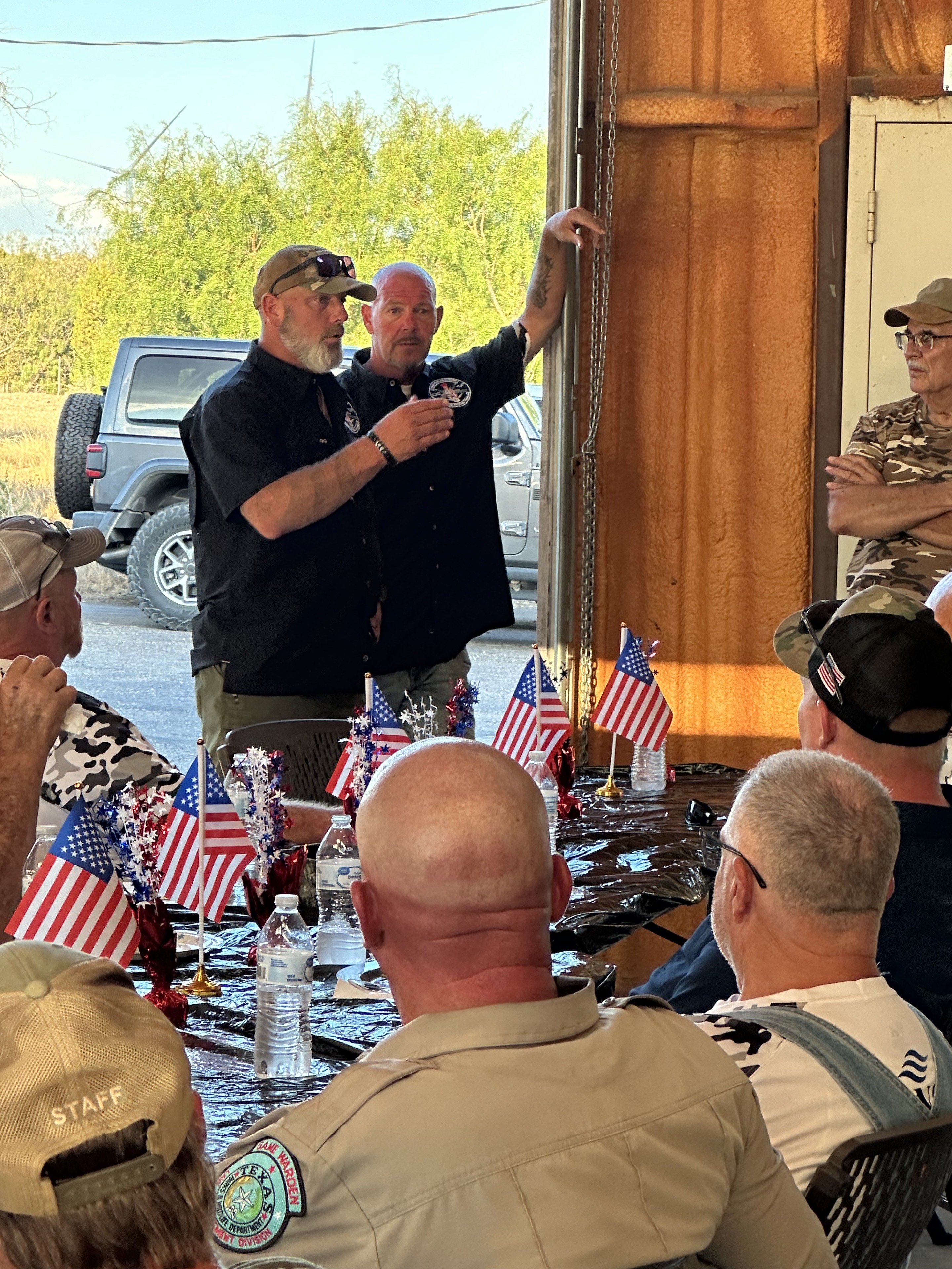 Two Vets Precision representatives speaking with veterans during a fellowship meal