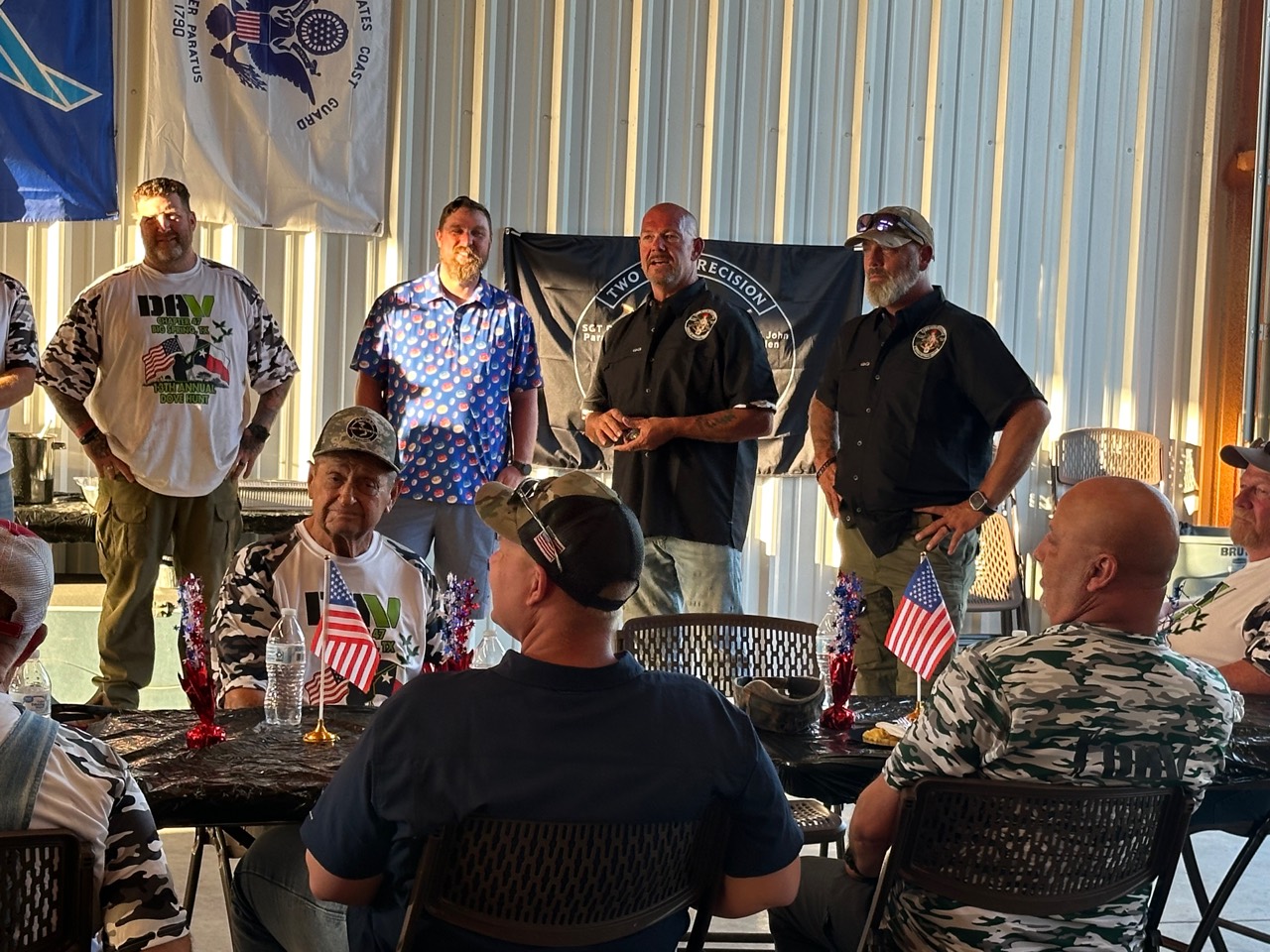 Veterans listening as Two Vets Precision representatives speak at the event