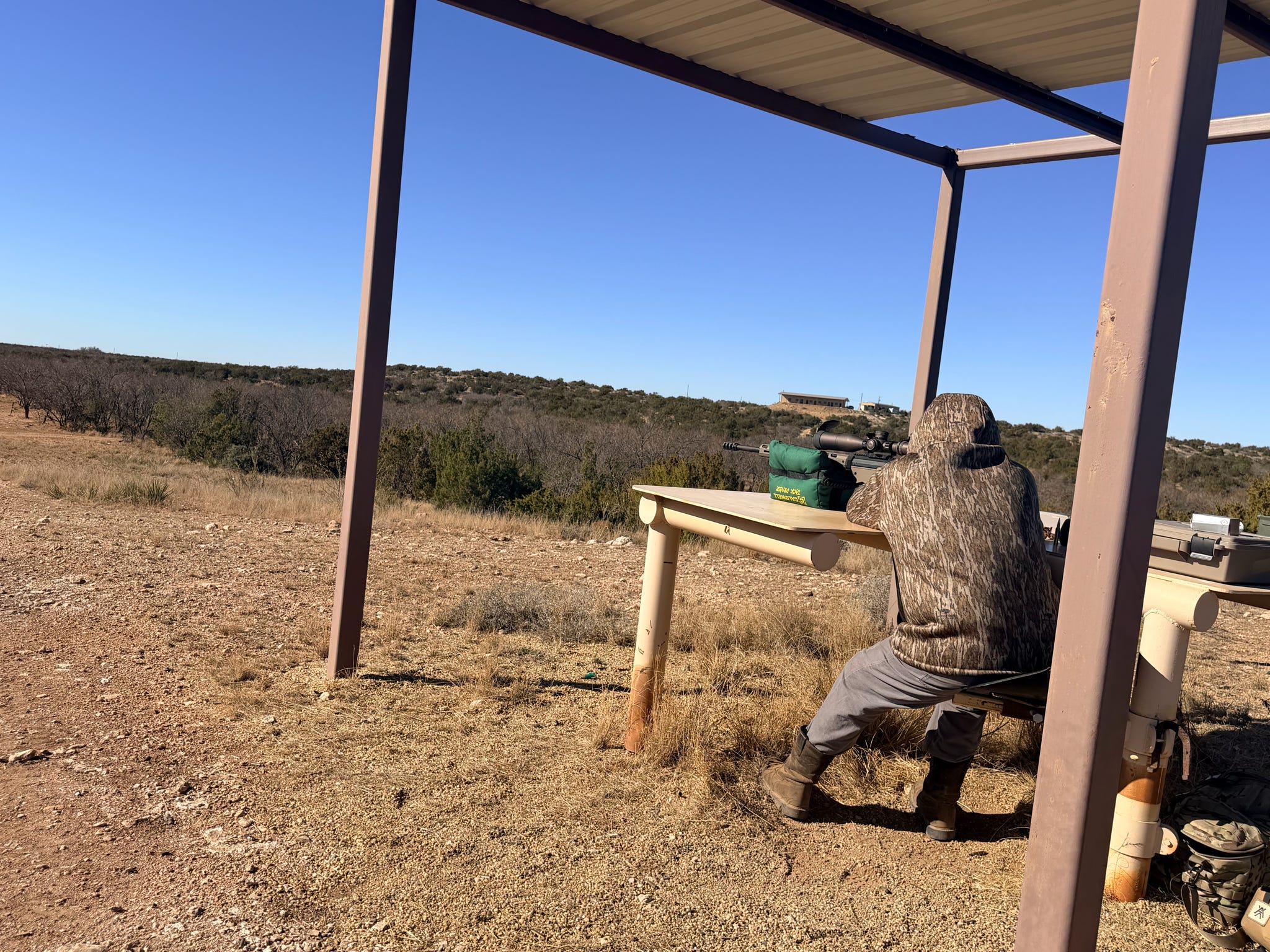 A veteran settling behind a precision rifle at the bench
