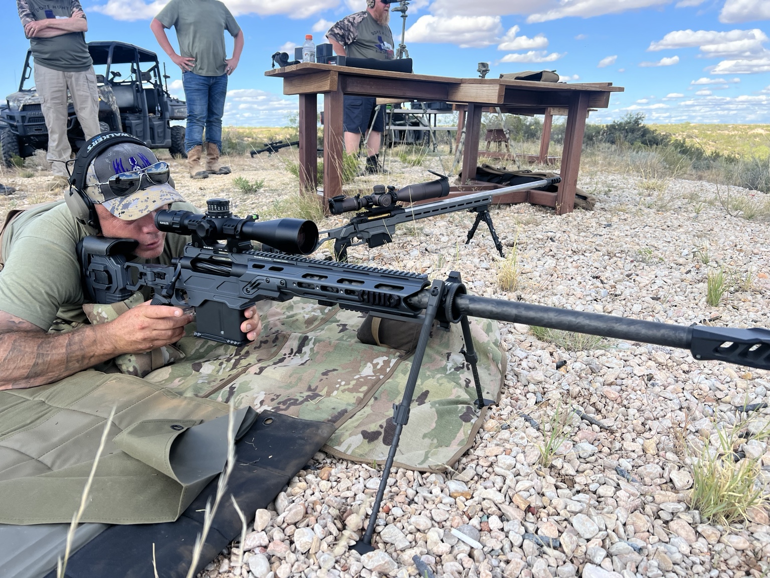A prone shooter settling into a long-range position