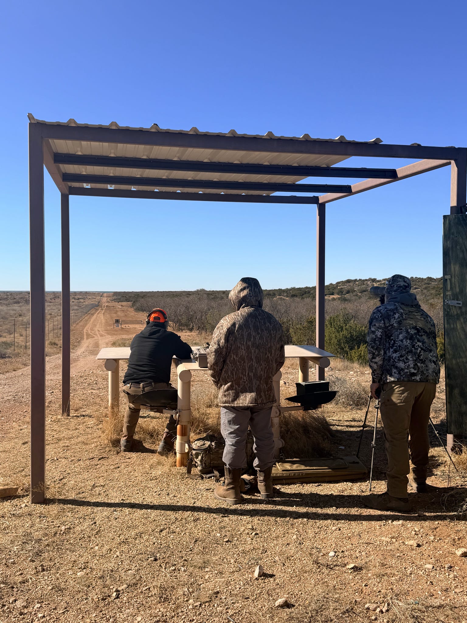Veterans working together at a covered range position